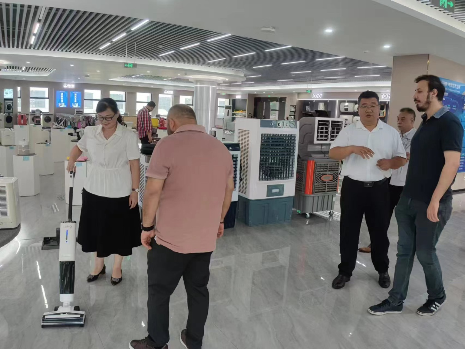 GlobalWay founder Burak Tuncay discussing products with a manufacturer during a factory visit in China